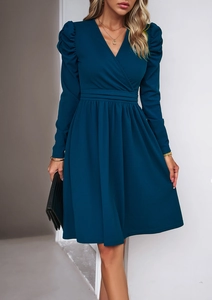 Detail of elegant V-neck long sleeve dress with puff sleeves and pleated waist design