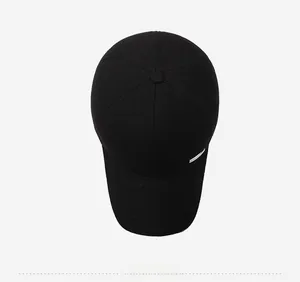 Overhead view of black cotton baseball cap with durable twill texture and silver trim