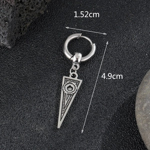 Detailed macro view of vintage silver steel hoop earring with a geometric triangle pendant