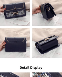 Detail view of navy blue crossbody bag with tweed panel and gold flower magnetic buckle