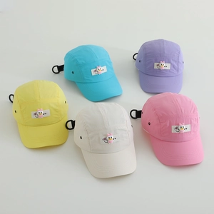 Detail view of colorful quick-dry kids baseball hats with cute duck patch and adjustable buckle