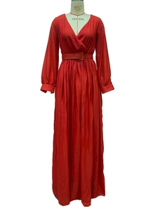Detail of red V-neck maxi dress with long sleeves and matching square buckle waist belt