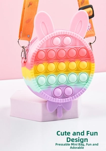 Macro shot of macaron rainbow pop-it silicone bag with bunny lollipop shape