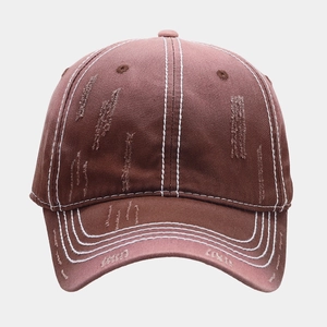 Detailed view of brown washed distressed baseball cap with white contrast stitching detail
