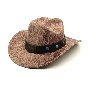 Detail of vintage brown cowboy hat featuring faux suede texture and turquoise star buckle