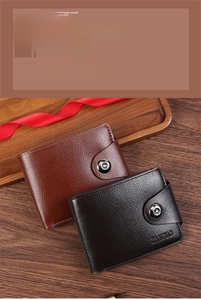 Detail of high-quality leather wallets in brown and black on a rustic wooden tray