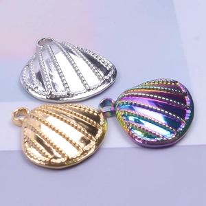 Macro shot of seashell-shaped stainless steel jewelry charms in silver, gold, and rainbow finish
