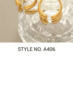 Detailed close-up of thick gold-plated C-shaped earrings with a high-polished finish