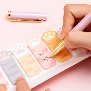 Creative colorful cat paw sticky notes set with writing pen on pink background