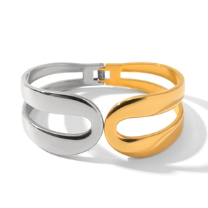 Detail view of two-tone 18k gold and silver stainless steel spring hinge cuff bracelet