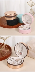 Detail view of round PU leather jewelry box interiors in pink, rose gold and mint colors