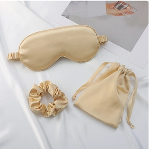 Three-piece champagne silk sleep set with eye mask, scrunchie and drawstring storage bag