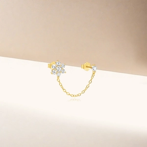Close-up of S925 sterling silver stamp on golden floral chain earrings with diamonds