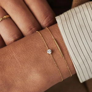 Close-up of S925 sterling silver heart bracelet with sparkling zircon on a woman's wrist