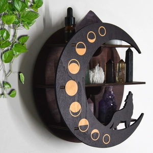 Detail of crescent moon wooden shelf with wolf silhouette and gold phase patterns