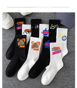 Flat lay of cotton crew socks with colorful graffiti art and smiley faces