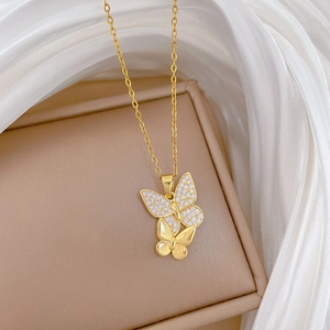 Gold titanium steel double butterfly necklace with zircon on white silk background