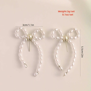 Detailed view of pearl bow earrings with silver needles and 5.5cm elegant tassels