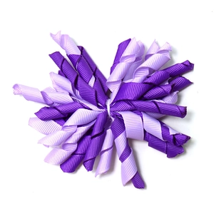 Handmade purple curly grosgrain ribbon hair clips for kids on a clean white background