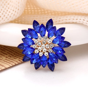 Macro detail of sunflower charm with navy blue rhinestones and gold alloy base