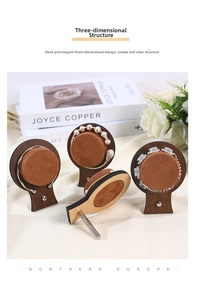 Detail view of walnut wood and brown velvet jewelry display stands for bracelets and watches