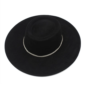 Detail of black suede wide brim hat with elegant white pearl bead trim decoration