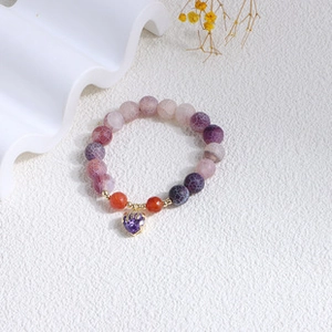 Detailed view of natural gradient beaded bracelet with a purple heart-shaped stone charm