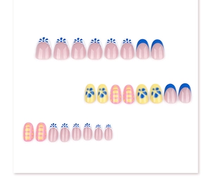 Detailed view of short round press-on nails featuring daisy motifs and French blue tips