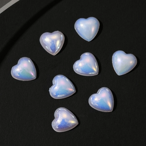 Macro shot of 3D iridescent heart charms for nail art and phone case decoration