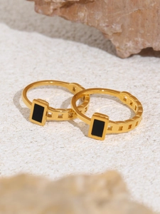 Macro detail of gold plated stainless steel ring set with black rectangular inlay on stone