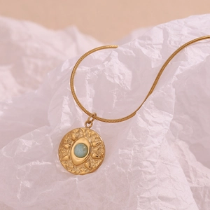 Macro shot of 18K gold plated snake chain with amazonite sunburst eye pendant