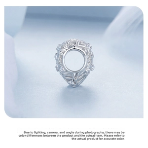 Macro shot of S925 sterling silver hollow leaf charm with sparkling cubic zirconia stones