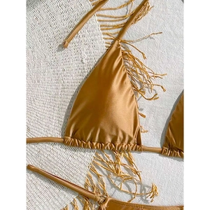 Solid bronze lace-up triangle bikini set with metallic glossy satin fabric on white fringe mat