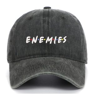 Close-up of white ENEMIES embroidery on washed denim baseball cap with colored dots