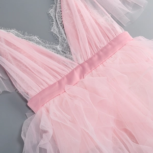 Detailed view of pink lace patchwork and multi-layer mesh texture on V-neck dress