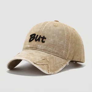 Detail of khaki washed cotton kids' baseball cap with BUT embroidery and frayed lightning patch