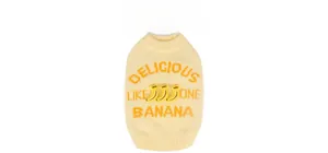 Detail view of knitted pet sweaters in vibrant yellow banana and green watermelon designs