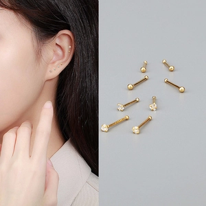 S999 Sterling Silver gold heart stud earrings on model and grey background