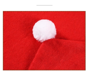 Close-up of high-quality red felt fabric texture with a fluffy white plush pompom detail