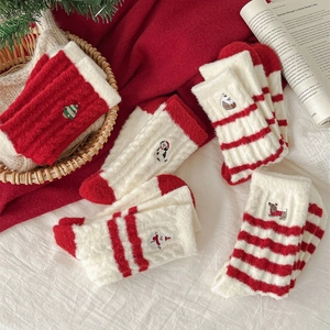 Thick warm Christmas socks with embroidered festive patterns in red and white colors
