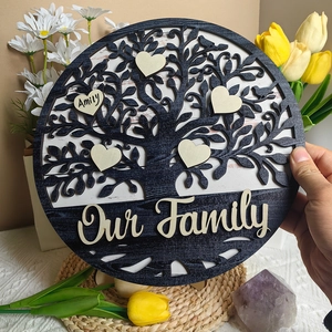 Macro shot of Our Family wooden tree plaque with personalized heart name tags