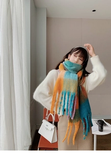 Close-up of thick rainbow plaid scarf with long fringes and fluffy mohair texture