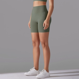 Detail showing high-waisted seamless yoga biker shorts in matte olive green fabric
