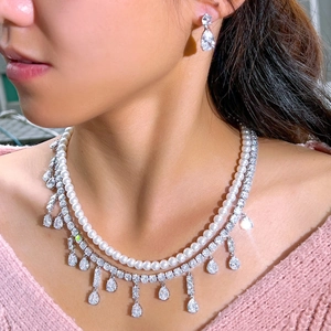 Elegant bridal jewelry set with pearl necklace, drop zircon fringe, and matching earrings
