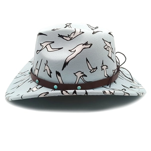 Close-up of light blue felt cowboy hat featuring seagull prints and a studded leather band