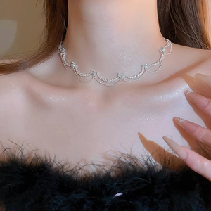 Detailed view of silver butterfly necklace with sparkling zircon and layered wavy chains