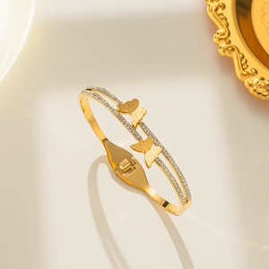 Golden titanium steel double butterfly bangle with sparkling pavé cubic zirconia