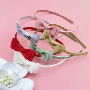 Set of colorful ribbed fabric bow headbands for girls in pink, red, and mint green