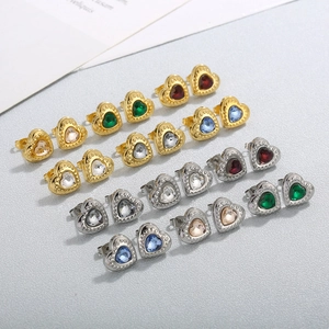 Detail of twelve pairs heart earrings with colorful crystals in gold and silver settings