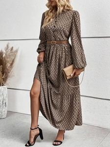 Detail of elegant retro brown print long-sleeve dress with matching belt and buttoned neckline